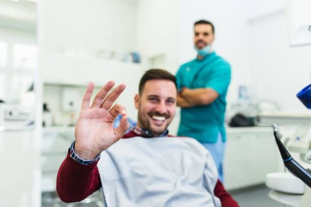Young good looking man having dental treatment at dentist's office.